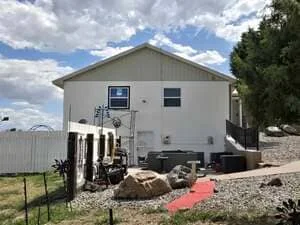 Concrete foundation pad with electrical and plumbing utilities installed, residential construction in progress