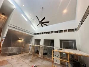 Commercial interior with drywall, recessed lighting, ceiling fan, and metal framing