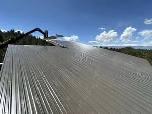 Standing seam metal roof with corrugated panels on pitched structure