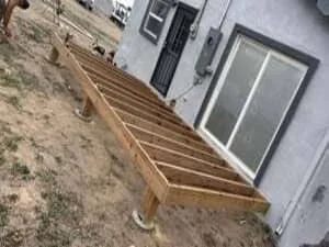 Pressure-treated wood deck framing with joists and beams during construction